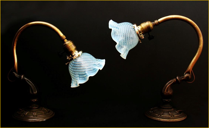 Title: Antique Brass Piano Lamps - Description: Cast bases with adjustable brass arms on this pair of antique piano lamps with blue swirl glass shades, gone to Minneapolis, Minnesota.